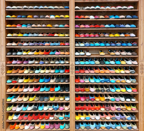Shelf in a shoe store. Multi-colored women's shoes on a shelf. Large selection of colors and sizes. Shop in Barcelona.