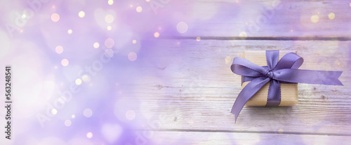 Gift box with purple bow an...