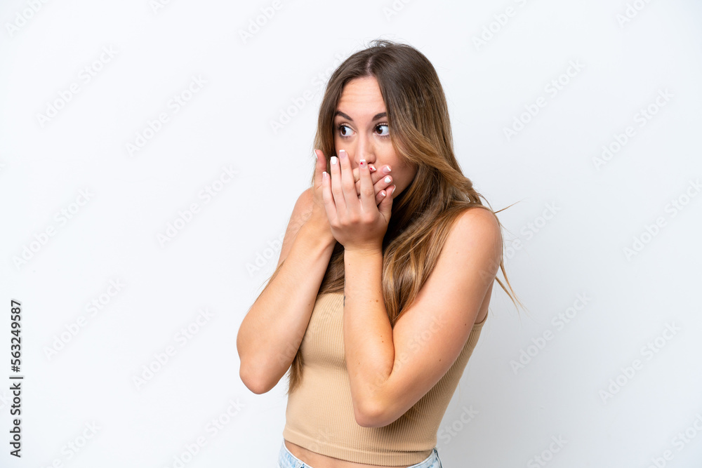 Young caucasian woman isolated on white background covering mouth and looking to the side Young caucasian woman isolated on white background covering mouth and looking to the side