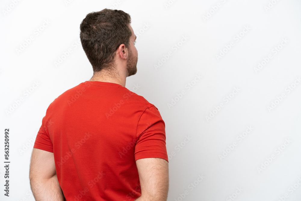 Young caucasian man isolated on white background in back position and looking back Young caucasian man isolated on white background in back position and looking back