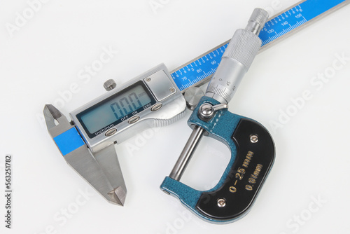 engineering digital calipers and micrometer on white background