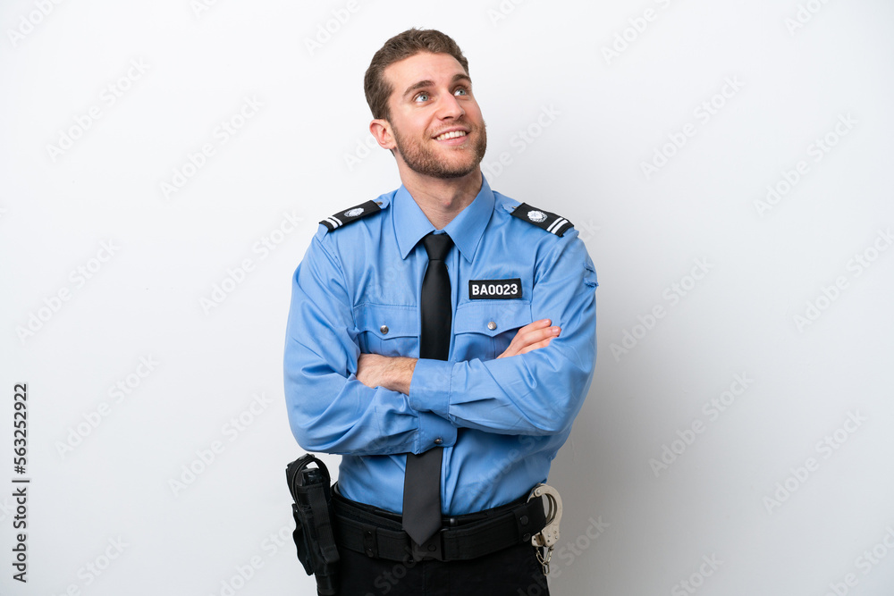 Young police caucasian man isolated on white background looking up while smiling Young police caucasian man isolated on white background looking up while smiling