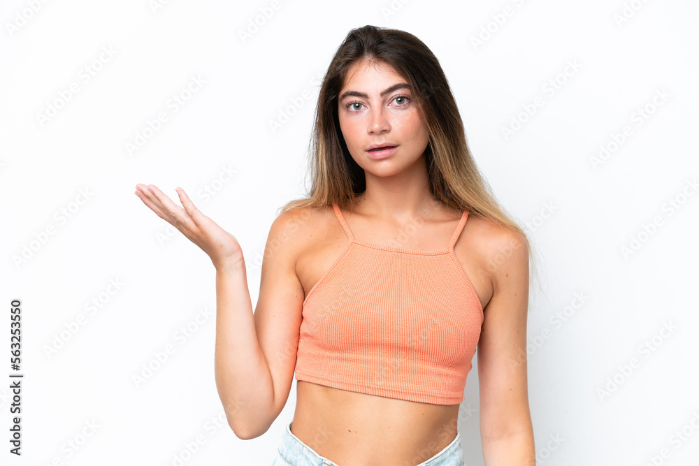 Young caucasian woman isolated on white background making doubts gesture