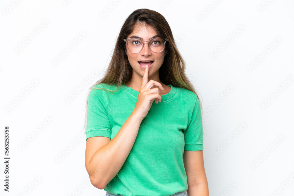 Young caucasian woman isolated on white background showing a sign of silence gesture putting finger in mouth Young caucasian woman isolated on white background showing a sign of silence gesture putting finger in mouth