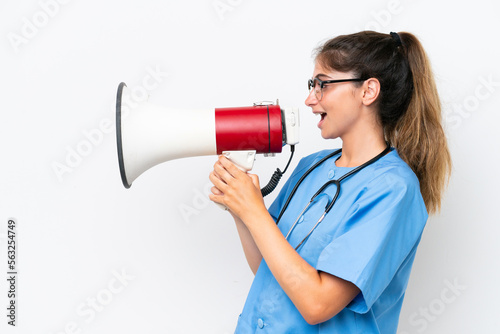Young nurse doctor woman isolated on white background shouting through a megaphone
