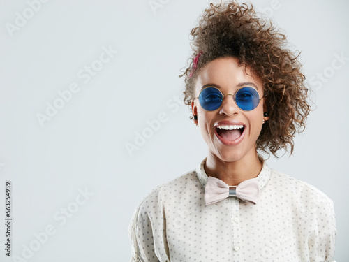 Sunglasses, smile and face of woman on a white background for summer, casual and trendy fashion style. Creative, beauty and zoom of happy girl isolated in studio with cosmetics, makeup and confidence
