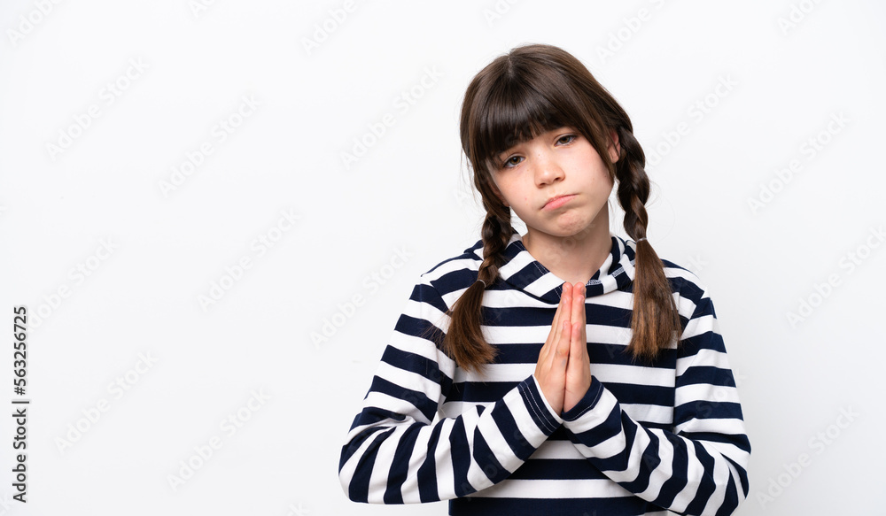 Little caucasian girl isolated on white background keeps palm together. Person asks for something Little caucasian girl isolated on white background keeps palm together. Person asks for something