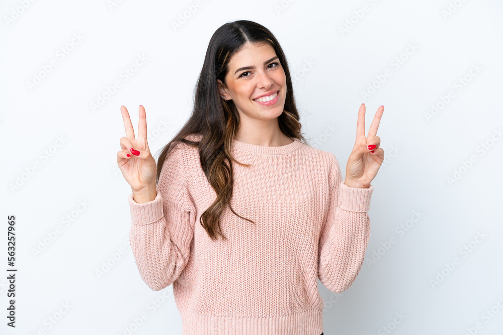 Young Italian woman isolated on white background showing victory sign with both hands Young Italian woman isolated on white background showing victory sign with both hands