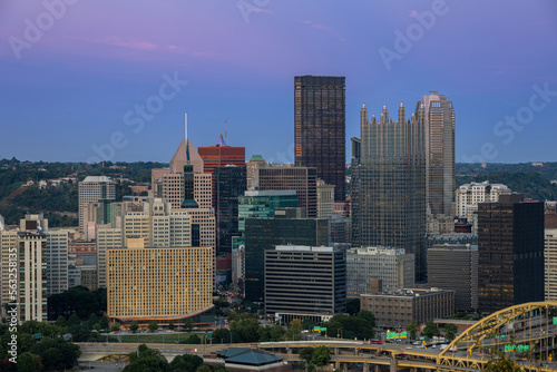 Cityscape of Pittsburgh and Evening Light. Fort Pitt Bridge. Blurry Ferry Cruise in Background Because of Long Exposure. Selective focus.