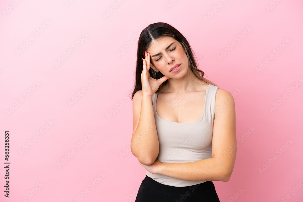Young Italian woman isolated on pink background with headache Young Italian woman isolated on pink background with headache
