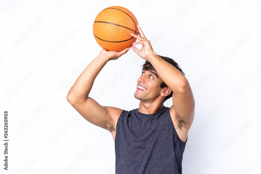 Young caucasian man isolated on white background playing basketball