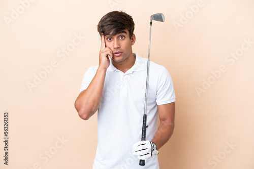 Young golfer player man isolated on ocher background thinking an idea