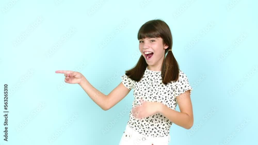 Little girl pointing to the side and presenting a product while smiling over isolated background Little girl pointing to the side and presenting a product while smiling over isolated background