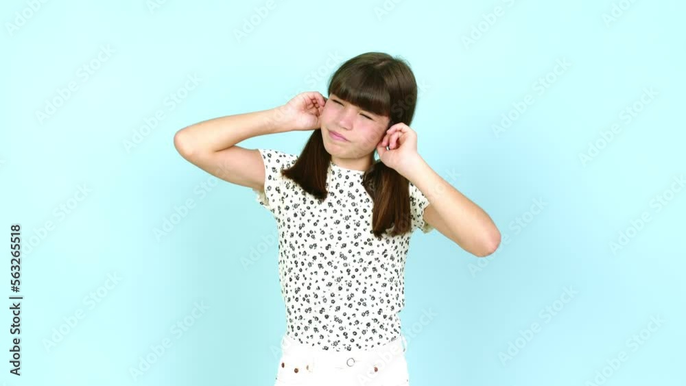 Little girl covering both ears with hands. Frustrated expression over isolated background Little girl covering both ears with hands. Frustrated expression over isolated background