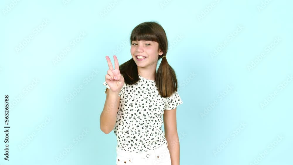 Little girl happy and counting with fingers over isolated background Little girl happy and counting with fingers over isolated background
