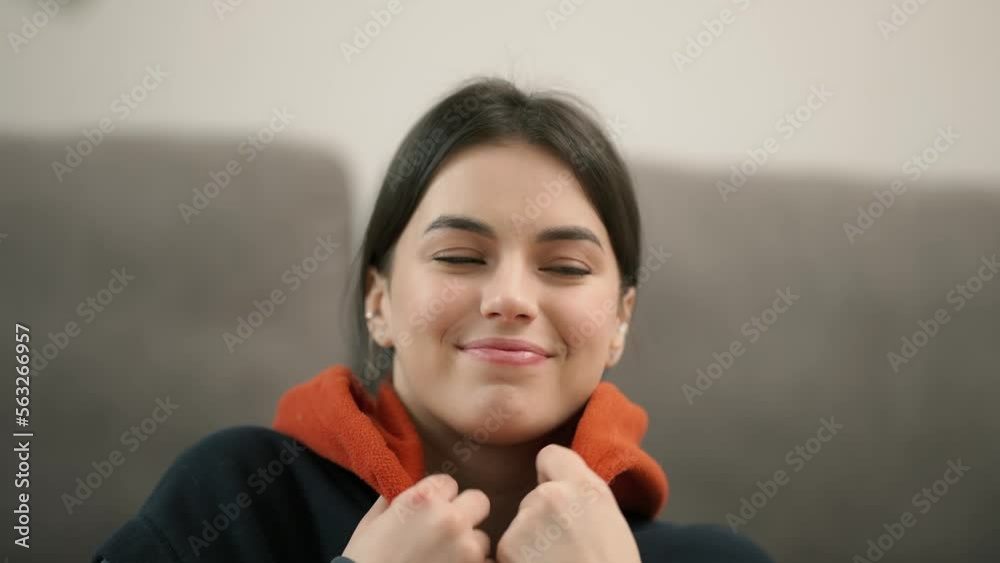 Indoor image of stylish brunette woman dressed in trendy hooded sweatshirt Indoor image of stylish brunette woman dressed in trendy hooded sweatshirt