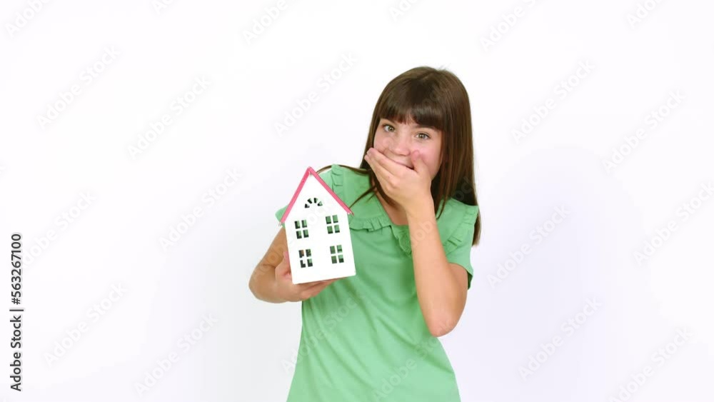 Little girl holding a little house over isolated background Little girl holding a little house over isolated background