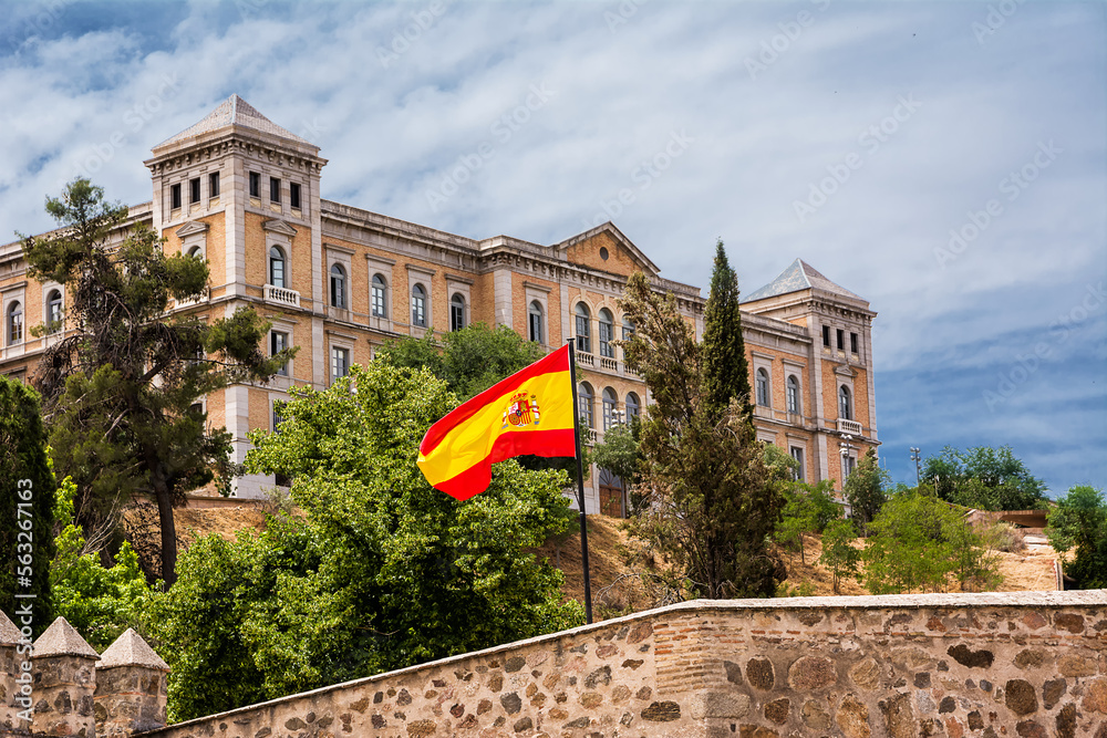 Provincial Palace of the Deputation and Spanish flag in the foreground - obrazy, fototapety, plakaty 