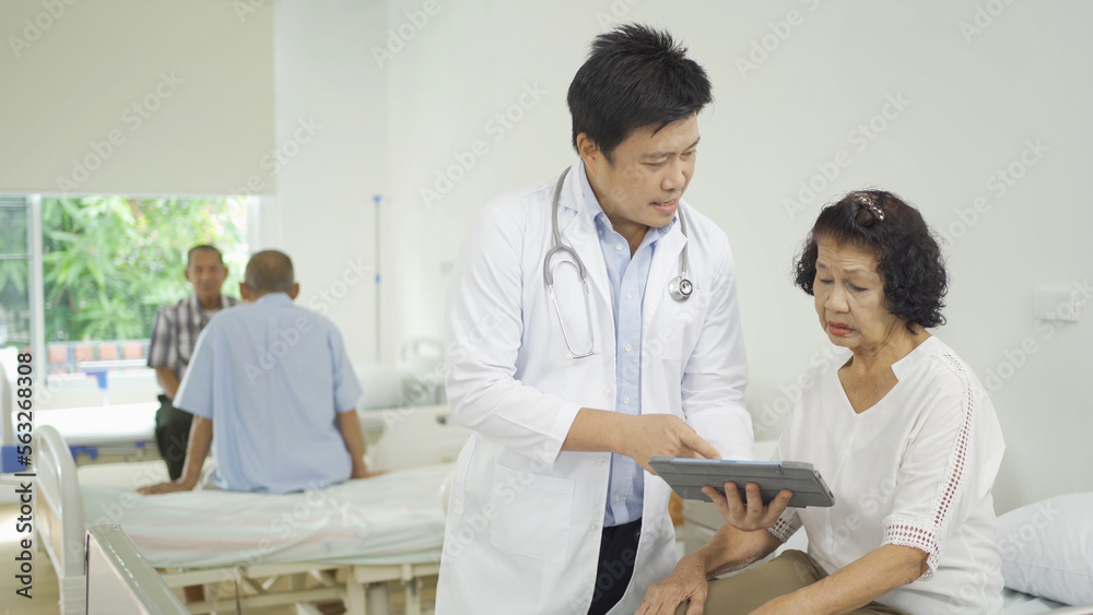An Asian doctor with a group of old elderly patient or pensioner in nursing home in hospital. Senior people lifestyle activity recreation. Health care physical therapy. An Asian doctor with a group of old elderly patient or pensioner in nursing home in hospital. Senior people lifestyle activity recreation. Health care physical therapy.