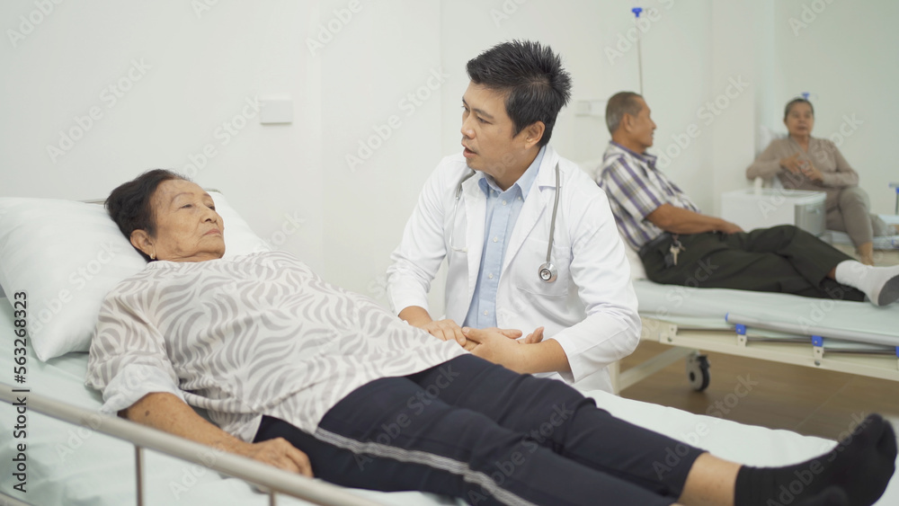 An Asian doctor with a group of old elderly patient or pensioner in nursing home in hospital. Senior people lifestyle activity recreation. Health care physical therapy. An Asian doctor with a group of old elderly patient or pensioner in nursing home in hospital. Senior people lifestyle activity recreation. Health care physical therapy.