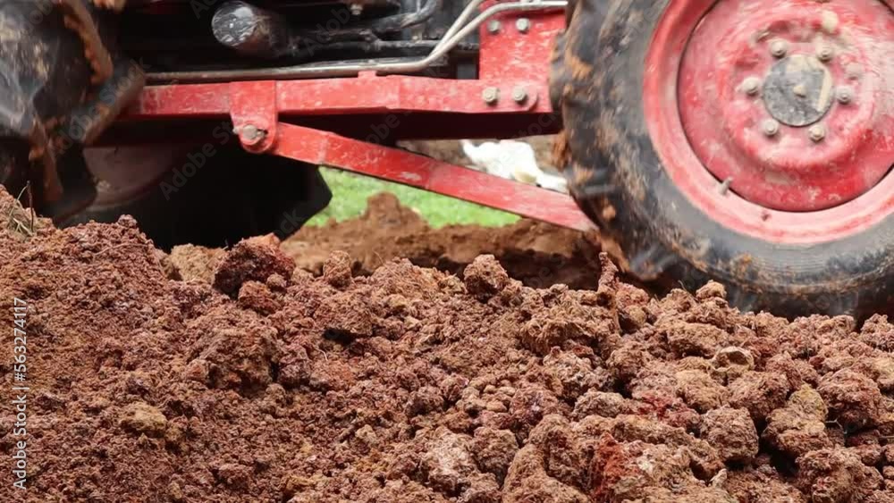The tractor is pushing the soil. focus foreground The tractor is pushing the soil. focus foreground