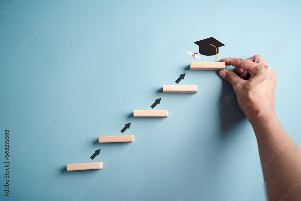 Steps of education leading to success goal. Taking strategic steps towards graduation. Career path and first for business, Graduation achievement goals concept. Graduation cap on wooden block. - obrazy, fototapety, plakaty 