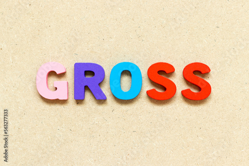 Color alphabet letter with word gross on wood background