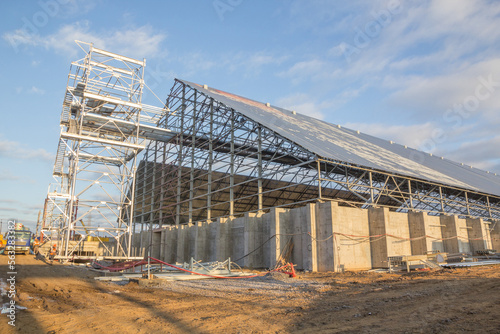 Construction of a closed silo for bulk grain. Reinforced concrete foundation and metal frame