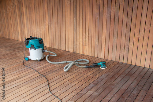 Obraz na plátně Professional deck maintenance tools orbital power sander connected to industrial
