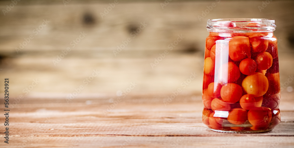 Pickled ripe tomatoes in a glass jar. Pickled ripe tomatoes in a glass jar.