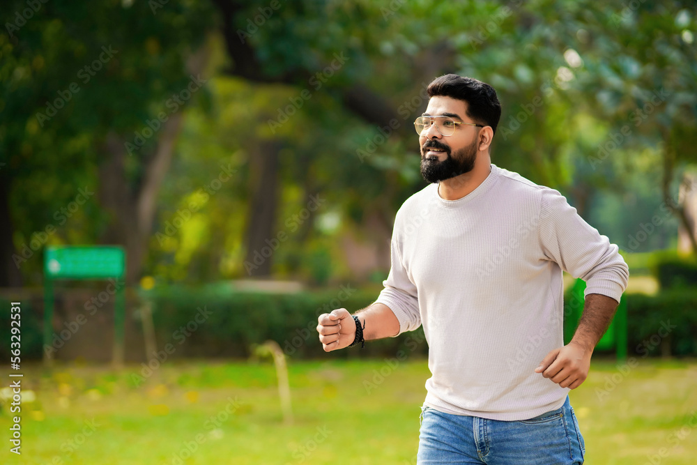 Young indian man running or jogging at park. Young indian man running or jogging at park.