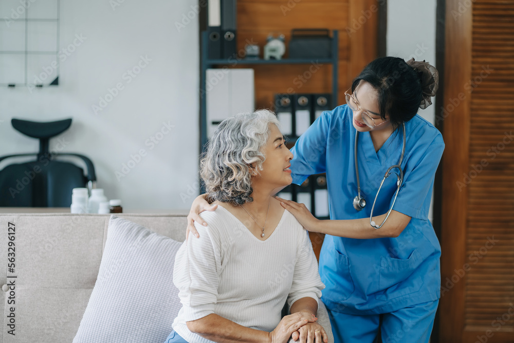 Fototapeta premium Female doctor touching patient's shoulder to encourage treatment.
