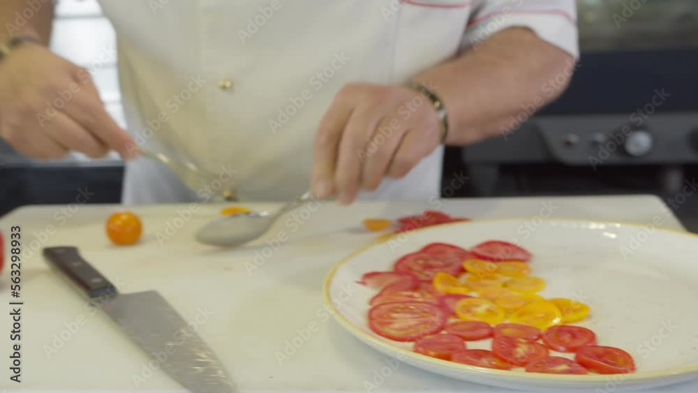 Chef serves chopped tomatoes on a plate Chef serves chopped tomatoes on a plate