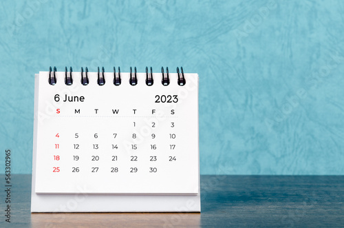 The June 2023 desk calendar on blue color background, Vintage style. photo