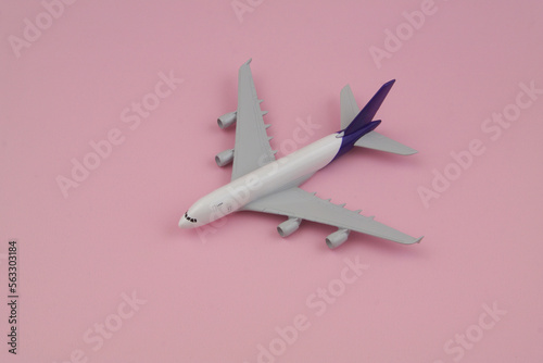 Airplane model on pink background, travel and transportation concept. 