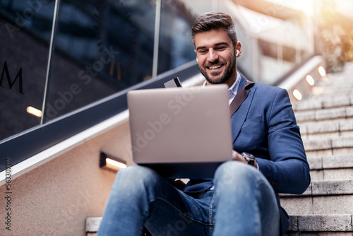 Businessman using credit card for online shopping
