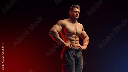 Strong man with muscular body. Sexy male bare torso. Shirtless athletic hot shirtless guy with abs posing holding his hands on belt