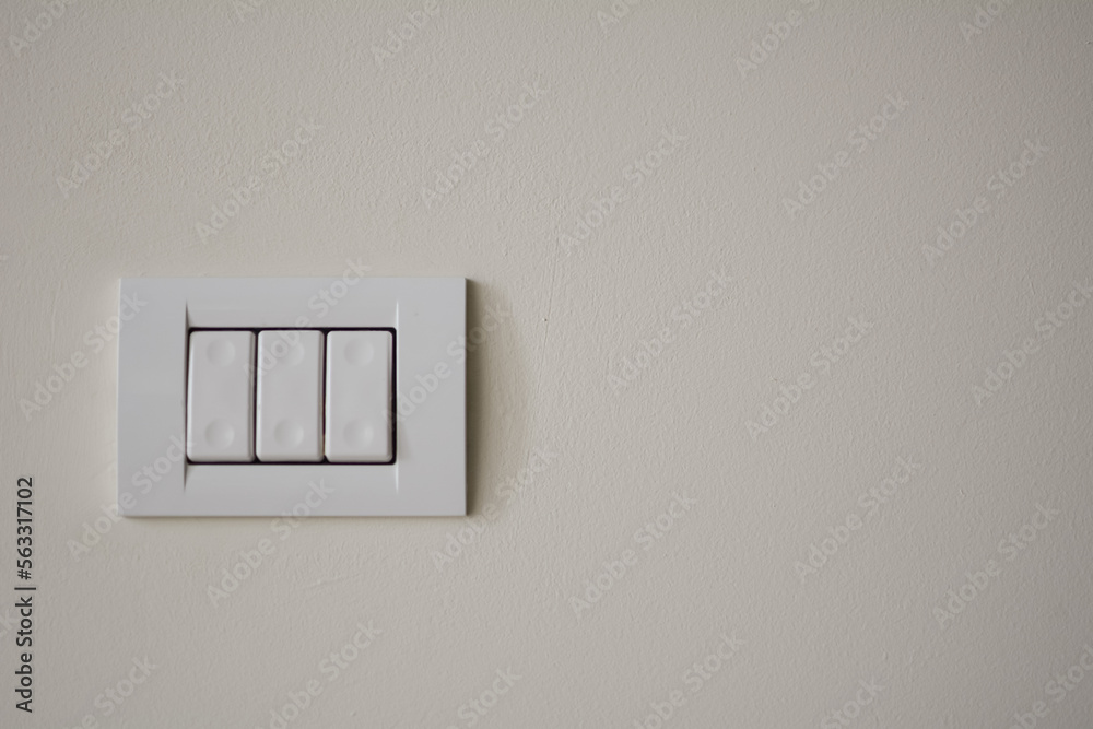 Contemporary modern electric light switches on on a light living room wall. House home utilities interior details elements Contemporary modern electric light switches on on a light living room wall. House home utilities interior details elements