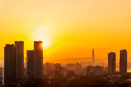 Gold sunset of Seoul cityscapes with high rise office buildings and skyscrapers in Seoul city, Republic of Korea in winter blue sky and cloud © lukyeee_nuttawut