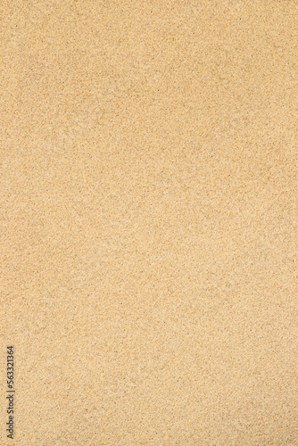 Sand textured background. Fine-grained texture of sandy beach surface in yellow color