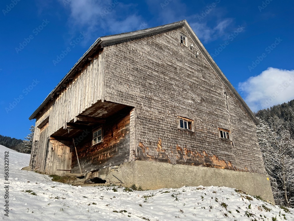 Indigenous alpine huts and wooden cattle stables in the Swiss Alps covered with fresh first snow over the Lake Walen or Lake Walenstadt (Walensee), Amden - Canton of St. Gallen, Switzerland / Schweiz Indigenous alpine huts and wooden cattle stables in the Swiss Alps covered with fresh first snow over the Lake Walen or Lake Walenstadt (Walensee), Amden - Canton of St. Gallen, Switzerland / Schweiz