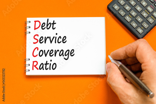 DSCR debt service coverage ratio symbol. Concept words DSCR debt service coverage ratio on white note on beautiful orange background. Business DSCR debt service coverage ratio concept. Copy space. photo