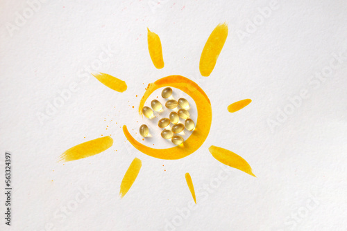 Tablets inside the drawing of the sun and the inscription: vitamin D.