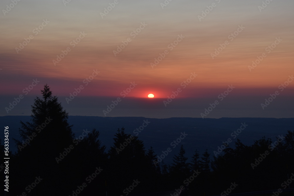 Photo of the sun during sunrise taken from the top of a mountain during a road trip in Abruzzo Italy
