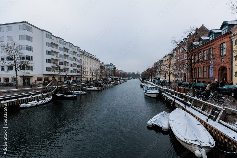 Canal in winter with colourful buildings in European city 