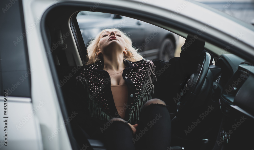 European sexy elegant woman in car, lady driving automobile, outdoors portrait. Woman on road, trip on beautiful day. Concept of women and auto