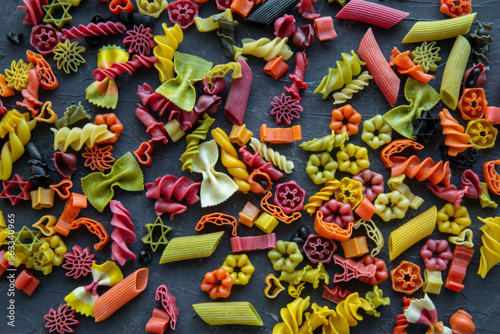 Assortment of different kind of dry pasta background, top view. Colorful pasta. 
