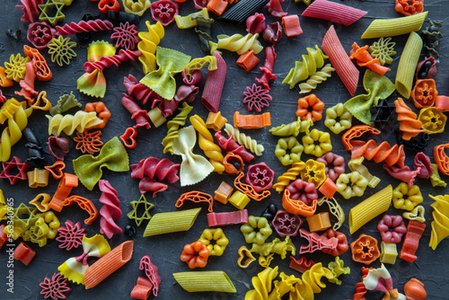 Assortment of different kind of dry pasta background, top view. Colorful pasta. 