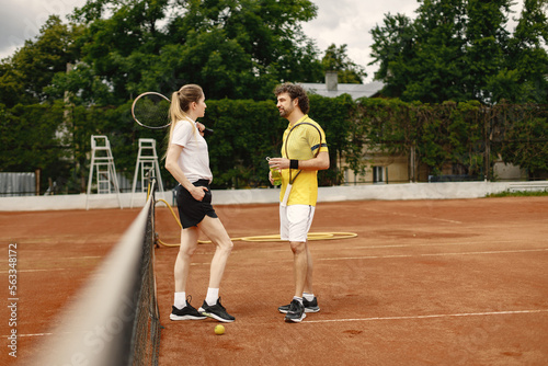 Two tennis players talking on a tennis court before the match