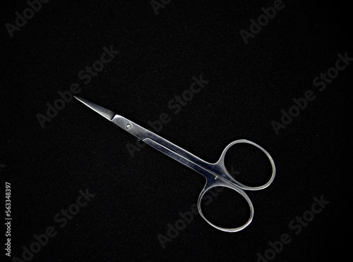 Manicure set on a black background. Scissors and nail tongs. Iron scissors and nail clippers.